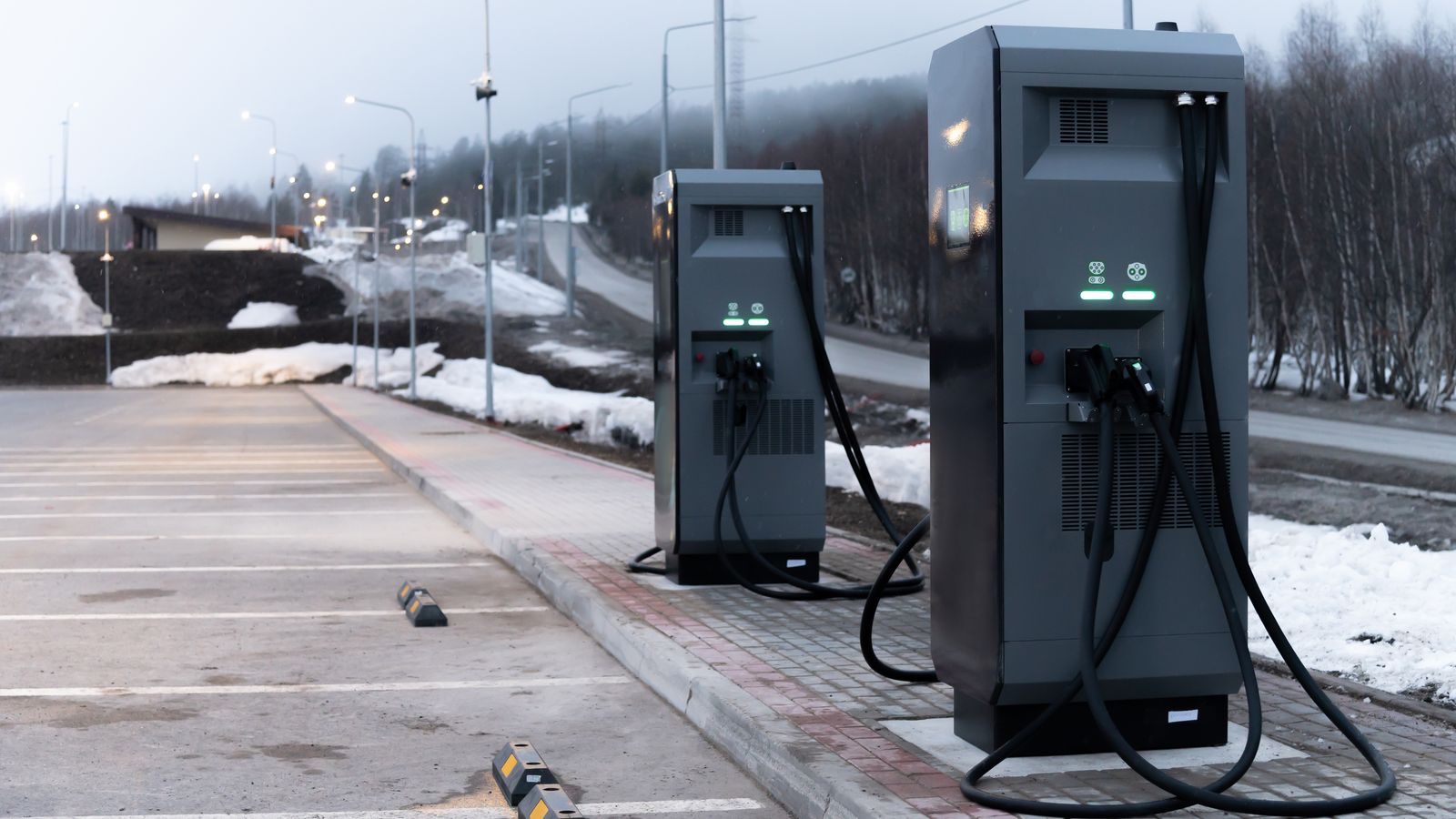 Two DC chargers in a parking lot.