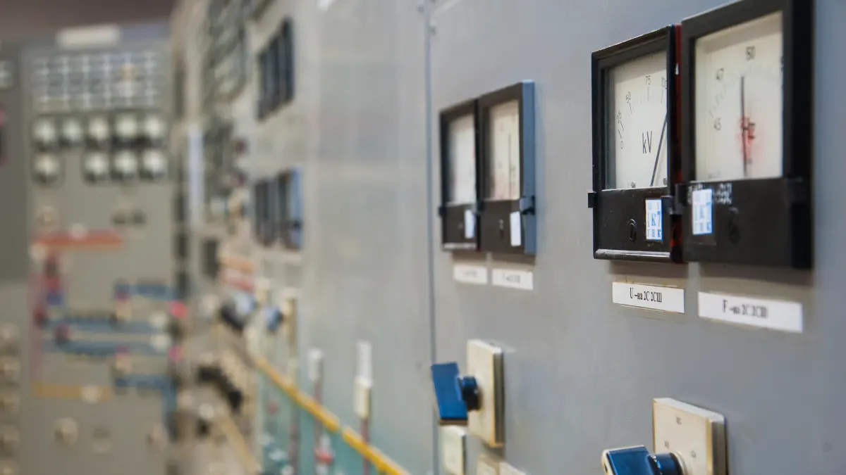 Metering instruments on an industrial switchboard.