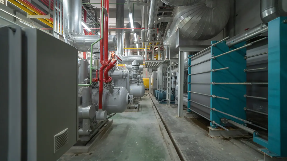 Aisle of a machine room with insulated piping.