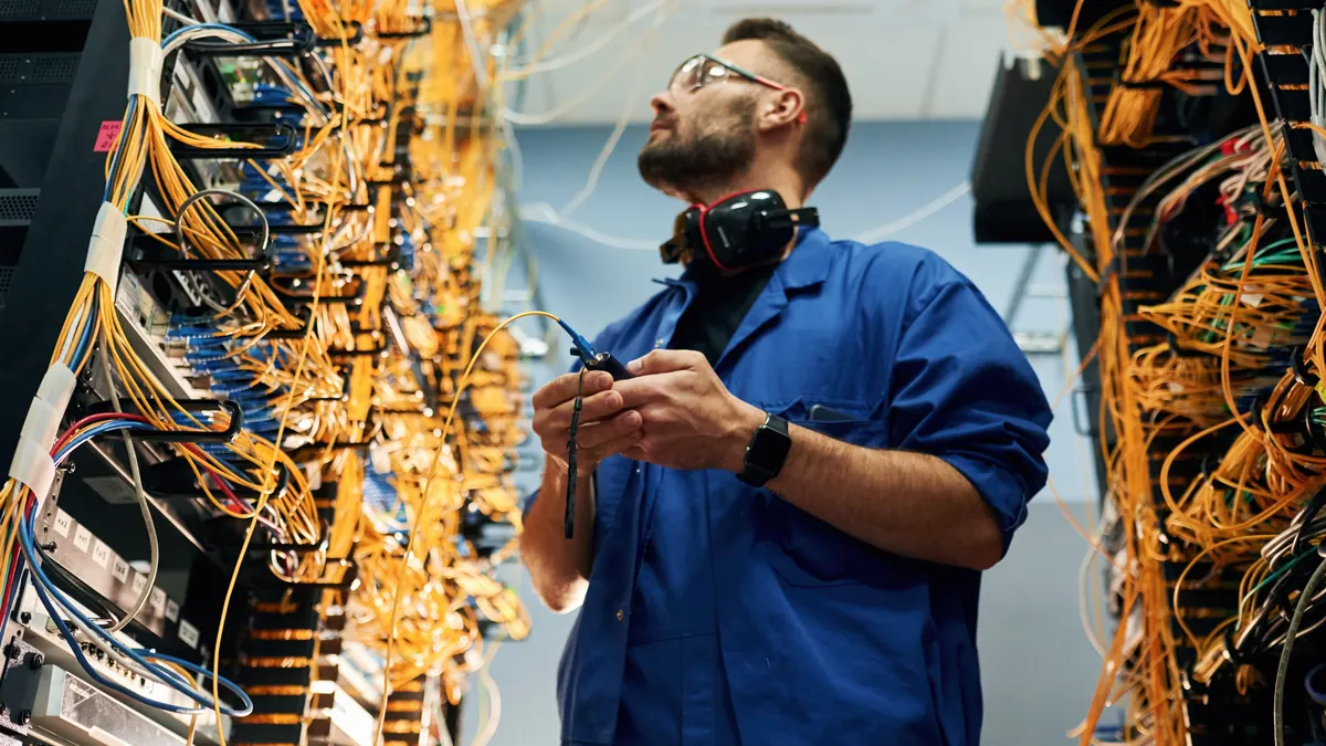 Technician works on data center cabling.