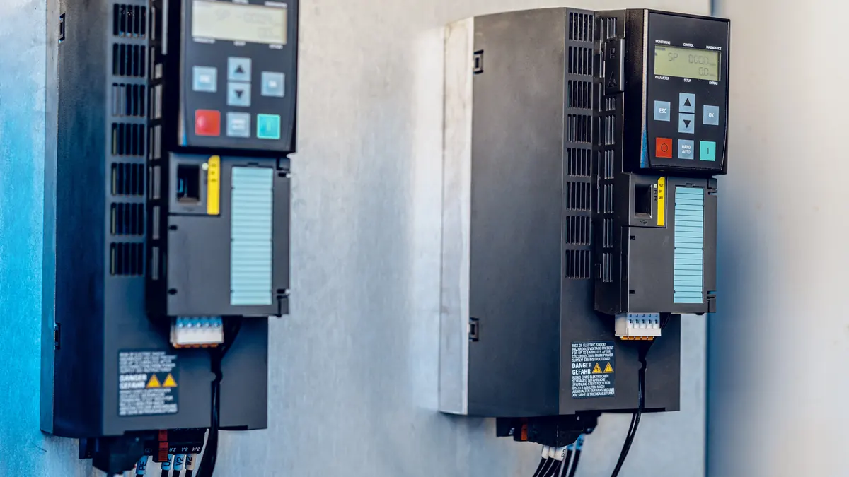 Wall-mounted variable frequency drives.