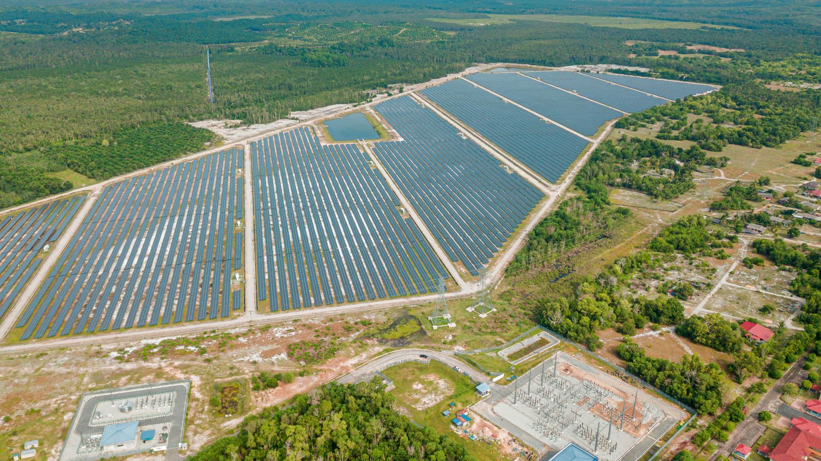 Aerial view of a solar park with its substation.