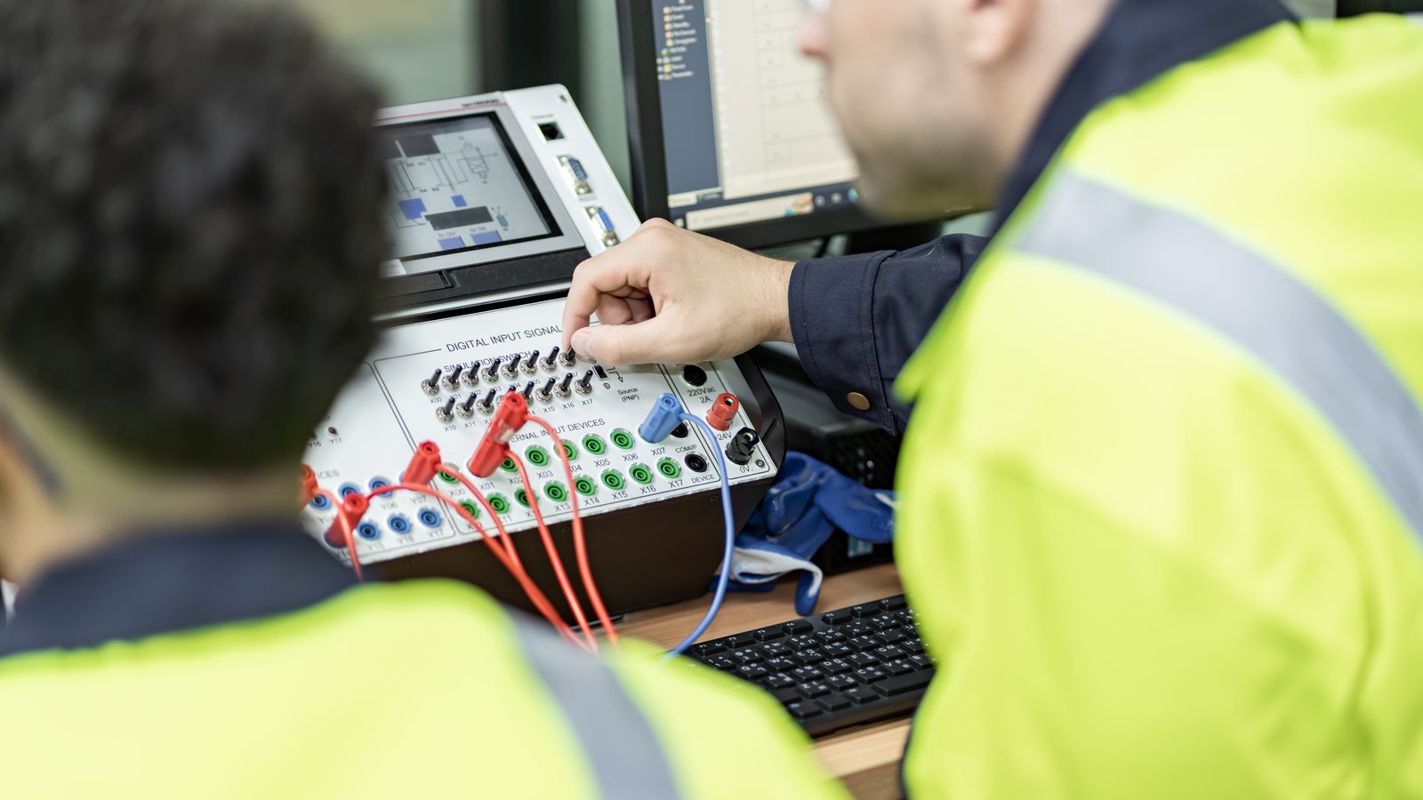 Technicians connect a power quality analyzer.