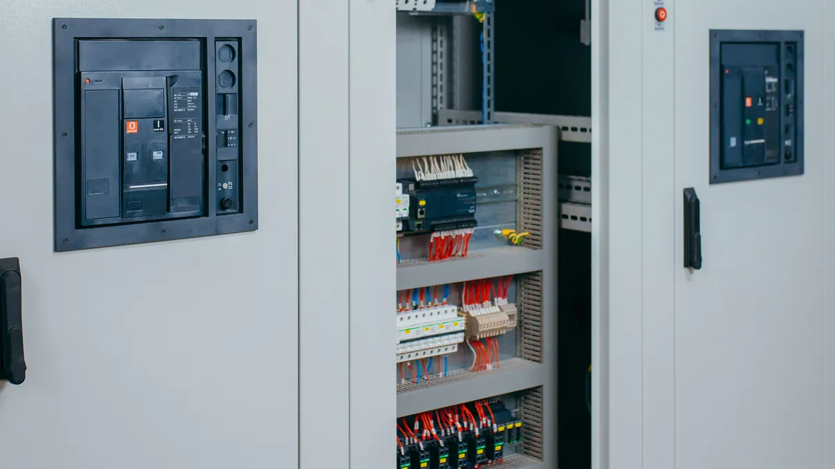 Switchgear with power circuit breakers and the door open showing the control wiring.
