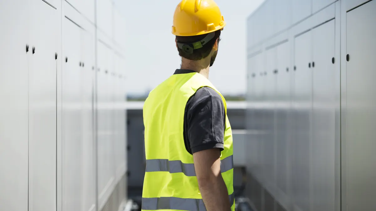 Technician between battery cabinets.