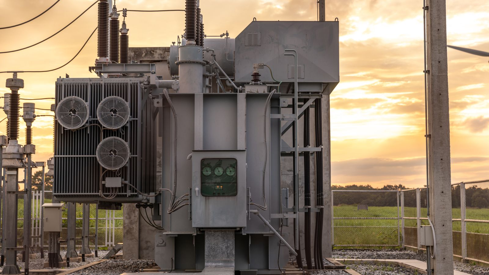 Power transformer at a substation at dusk.