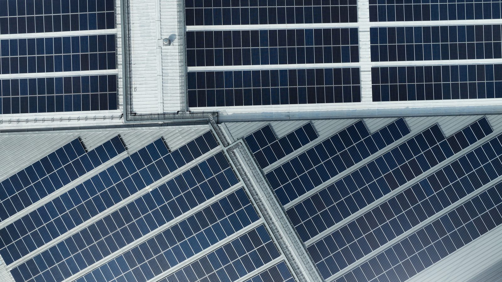 Solar panels on the facade and roof of an industrial building.