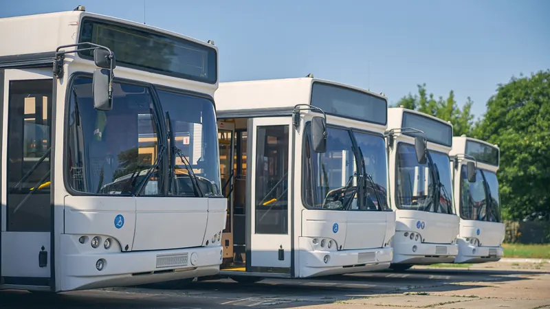 Employee transport buses parked in the yard.